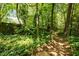 Wooded area with a winding path, creating a peaceful retreat and an opportunity to connect with nature at 111 Lattimore Ln, Durham, NC 27713