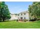 Expansive backyard with lush green lawn, mature trees, and a spacious deck, perfect for outdoor living at 114 Seastone St, Raleigh, NC 27603