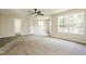 Carpeted bedroom features a ceiling fan and two big windows for lots of light at 114 Seastone St, Raleigh, NC 27603