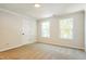 Bright bedroom with carpet and two windows providing ample natural light and a door at 114 Seastone St, Raleigh, NC 27603
