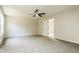 Large bedroom with carpet featuring a ceiling fan and neutral paint at 114 Seastone St, Raleigh, NC 27603