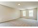 Spacious bedroom with neutral walls, carpet, and two windows providing natural light at 114 Seastone St, Raleigh, NC 27603