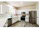 Modern kitchen equipped with stainless steel appliances and white cabinetry at 114 Seastone St, Raleigh, NC 27603