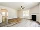 Bright living room featuring wood floors, a fireplace, and a ceiling fan at 114 Seastone St, Raleigh, NC 27603