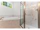 Elegant bathroom featuring a soaking tub and glass enclosed tiled shower at 121 Quarterhorse Dr, Louisburg, NC 27549