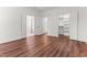 Bedroom with wood-look floors and open closet with attached bath with tub at 121 Quarterhorse Dr, Louisburg, NC 27549