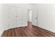 Bedroom with wood flooring, white trim, white doors, and a walk-in closet at 121 Quarterhorse Dr, Louisburg, NC 27549