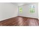 Bright bedroom featuring wood floors and natural light from two windows at 121 Quarterhorse Dr, Louisburg, NC 27549
