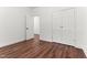Bedroom with wood flooring, white trim, white doors, and a walk-in closet at 121 Quarterhorse Dr, Louisburg, NC 27549