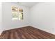 Bedroom with wood flooring, a double-hung window, and white trim at 121 Quarterhorse Dr, Louisburg, NC 27549