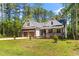 Inviting exterior view of a two-story home featuring a covered porch, two-car garage, and a manicured front lawn at 121 Quarterhorse Dr, Louisburg, NC 27549