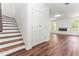 Interior view of the home features hardwood floors, a staircase, and closet leading into the Living Room at 121 Quarterhorse Dr, Louisburg, NC 27549