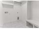 Functional laundry room with white tile flooring and built in bench at 121 Quarterhorse Dr, Louisburg, NC 27549