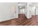 Living room showcasing hardwood floors and natural light with view into the kitchen at 121 Quarterhorse Dr, Louisburg, NC 27549