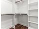Spacious walk-in closet with wooden closet rods and built-in shelving at 121 Quarterhorse Dr, Louisburg, NC 27549