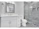 Modern bathroom featuring vanity, mirror and tiled shower with glass door at 1213 Grant St, Durham, NC 27701