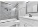 Bathroom featuring modern vanity, mirror and tiled shower with glass door at 1213 Grant St, Durham, NC 27701