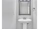 Modern powder room with pedestal sink, mirror, and neutral color scheme at 1213 Grant St, Durham, NC 27701