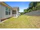 Expansive backyard featuring a retaining wall, lush lawn, and a covered porch area for outdoor enjoyment at 136 Durie Way, Garner, NC 27529