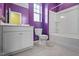 Bright bathroom featuring a white vanity, toilet, and a shower-tub combination at 136 Durie Way, Garner, NC 27529