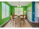 Bright dining room with modern lighting, neutral tones, and a sliding glass door to a porch or patio at 136 Durie Way, Garner, NC 27529