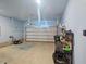 Spacious garage with ample storage, an automatic door, and a lawnmower at 136 Durie Way, Garner, NC 27529