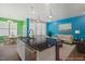 Open-concept design: kitchen island with a dark countertop and a view of a living room at 136 Durie Way, Garner, NC 27529
