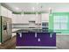 Modern kitchen featuring stainless steel appliances, white cabinets, a dark island and backsplash at 136 Durie Way, Garner, NC 27529