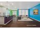 Virtually staged living room with colorful walls and a neutral-toned sofa at 136 Durie Way, Garner, NC 27529