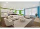 Spacious, virtually staged living room with bright, colorful walls and neutral furniture at 136 Durie Way, Garner, NC 27529