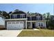 Charming two-story home featuring a stone facade and a two-car garage at 15 Decatur Dr, Fuquay Varina, NC 27526