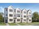 New construction shows townhome exteriors with white siding, black trim, and sidewalks leading to front doors at 1508 Crescent Townes Way, Raleigh, NC 27604