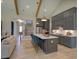 Kitchen with modern appliances and island with seating, connected to stairs that go to the second floor at 16 Calming Pl Pl, Fuquay Varina, NC 27526