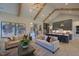 Open-concept living space flows from the living room to the kitchen and features hardwood floors and neutral decor at 16 Calming Pl Pl, Fuquay Varina, NC 27526