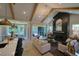 Bright living room boasts vaulted ceilings, wooden beams, sleek fireplace, and access to a screened-in porch at 16 Calming Pl Pl, Fuquay Varina, NC 27526