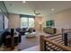 Upstairs living room with neutral paint, modern furniture, and large windows with backyard views at 16 Calming Pl Pl, Fuquay Varina, NC 27526