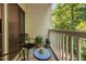 Balcony with chairs and table, perfect for relaxation, with lovely wooded view at 1851 Trailwood Heights Ln # 201, Raleigh, NC 27603
