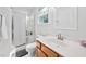 Bathroom featuring a glass door shower, white vanity, and window at 1851 Trailwood Heights Ln # 201, Raleigh, NC 27603
