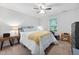 Bedroom with large bed, ceiling fan, carpet, and bright window at 1851 Trailwood Heights Ln # 201, Raleigh, NC 27603