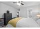 Bedroom with a large bed and ceiling fan with a view of the en suite bathroom and walk-in closet at 1851 Trailwood Heights Ln # 201, Raleigh, NC 27603