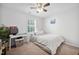 Carpeted bedroom featuring a ceiling fan, desk, and closet at 1851 Trailwood Heights Ln # 201, Raleigh, NC 27603