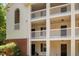 Condo building with white siding, black doors, and white-railed balconies at 1851 Trailwood Heights Ln # 201, Raleigh, NC 27603