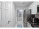 Kitchen with white cabinets, stainless steel appliances, and a view into the laundry room at 1851 Trailwood Heights Ln # 201, Raleigh, NC 27603