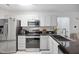 Bright kitchen featuring stainless steel appliances, black granite countertops, and white cabinets at 1851 Trailwood Heights Ln # 201, Raleigh, NC 27603