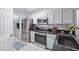 Modern kitchen with stainless steel appliances, white cabinets, and black countertops at 1851 Trailwood Heights Ln # 201, Raleigh, NC 27603