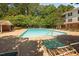 Community swimming pool with lounge chairs on a sunny day at 1851 Trailwood Heights Ln # 201, Raleigh, NC 27603