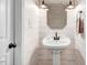 Half bathroom featuring plank accent wall, pedestal sink, accent lights, and a towel rack at 201 Shady Lane Dr, Smithfield, NC 27577