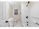 Full bathroom featuring a white vanity, toilet, shower-tub combo with white tile, and a window at 201 Shady Lane Dr, Smithfield, NC 27577