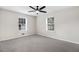 Bedroom featuring a ceiling fan, two windows, neutral walls, and soft, plush carpeting at 201 Shady Lane Dr, Smithfield, NC 27577