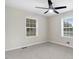 Bright bedroom featuring two windows, neutral walls, ceiling fan, and plush carpeting at 201 Shady Lane Dr, Smithfield, NC 27577